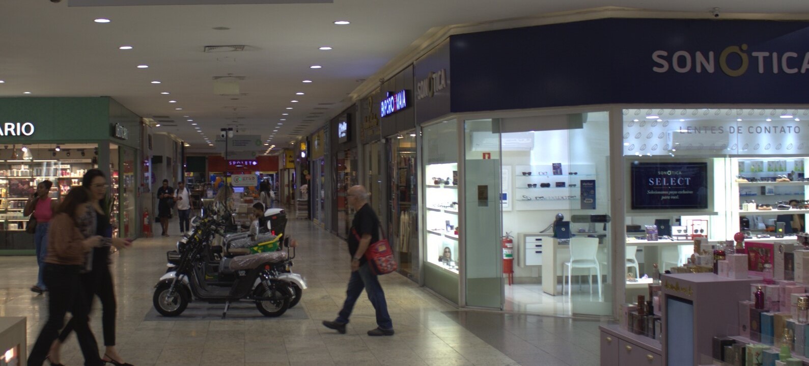 Corredor interno do Masterplace Mall, com lojas e visitantes